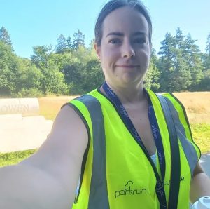 A selfie of Sian in a volunteer vest. club secretary